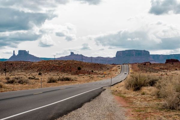 Road through Utah with rock formations in the background