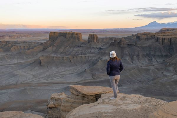 Skyline View and Moonscape Overlook with a girl in a blue oat, white hat a