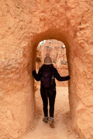 girl hiking through hoodoo in Bryce Canyon