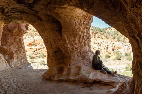 girl wearing hiking boots in cave near Kanab Utah