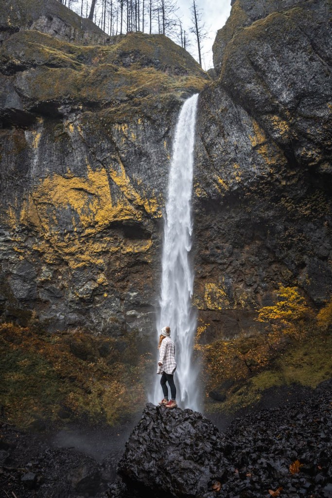 girl standing in front of waterfall in the columbia river gorge