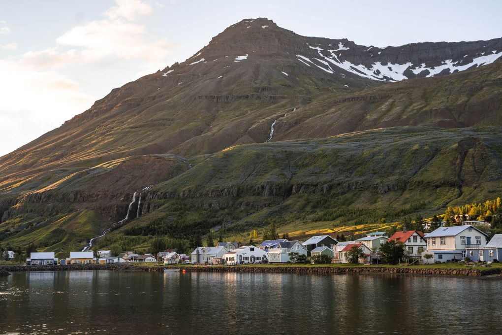 morning view of Seydisfjordur, small town with waterfalls in the mountains