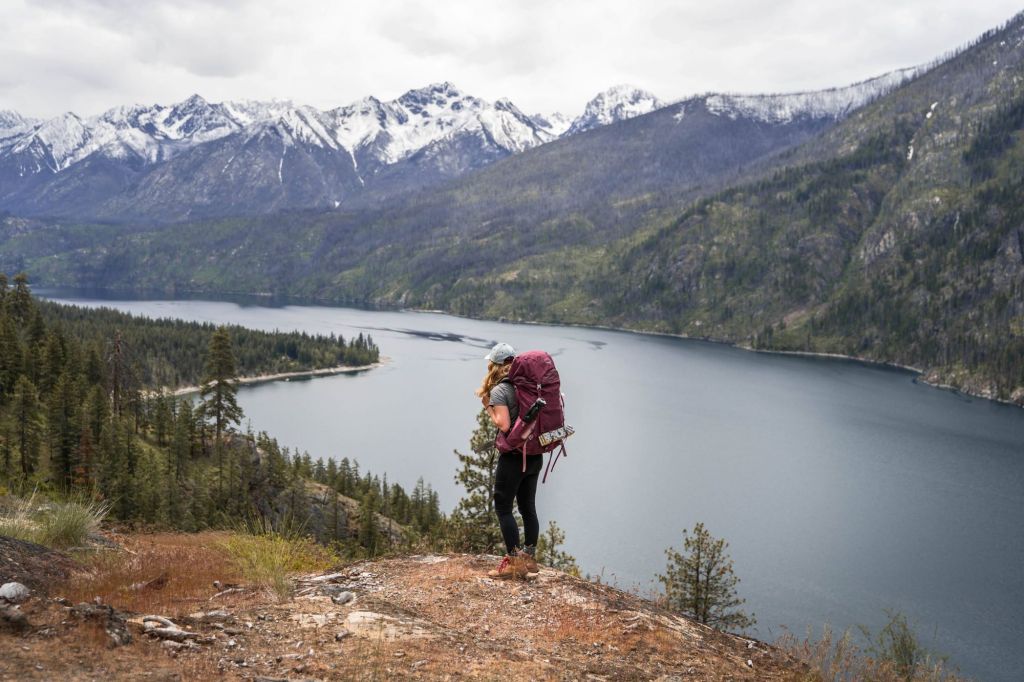 girl hiking to stehekin washington on the lake chelan lakeshore trail