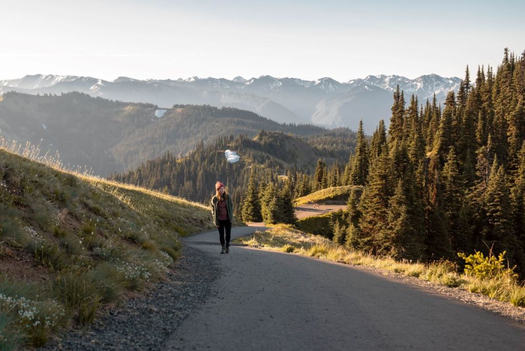 woman hiking alone on a trail in the mountains