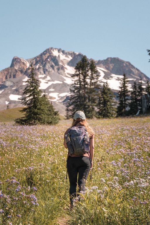 girl with backpack on hiking in front of Mount Hood in Oregon