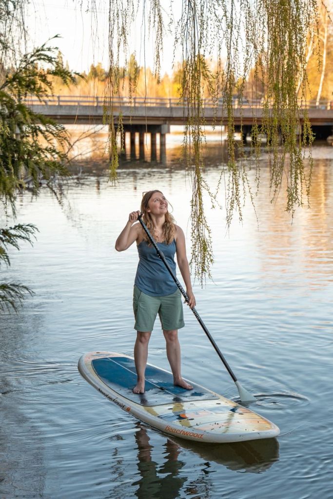 girl in summer attire kayaking on the Deschutes River in Bend