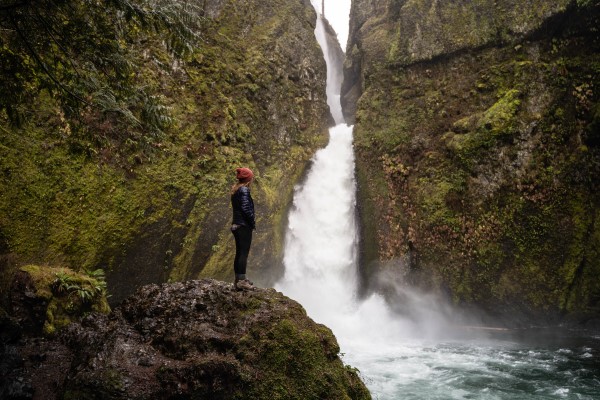 girl looking at Wahclella Falls in Oregon